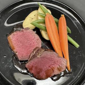 two slices of venison tenderloins with assorted vegetables